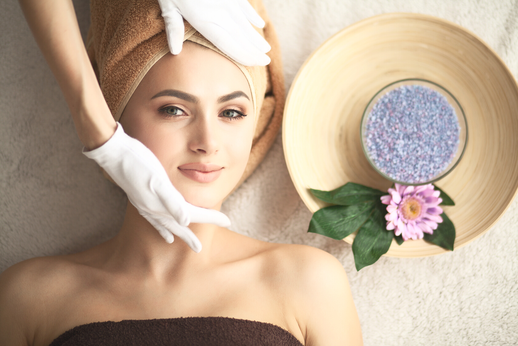 Woman under professional facial massage in beauty spa